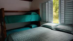 Postel nebo postele na pokoji v ubytování Sítio Encontro das Águas Brotas