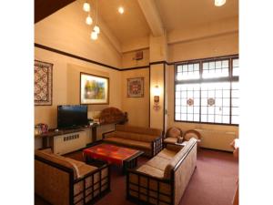 a living room with couches and a tv at Hotel Mount Shiga - Vacation STAY 95300v in Yamanouchi