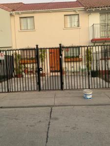 a black fence in front of a house at Hostal del Rosario La Serena in La Serena