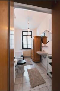 a bathroom with two toilets and a sink and a mirror at Castle View Appartment in Nuremberg
