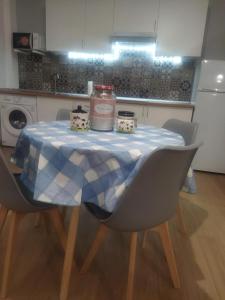 a table with a blue and white table cloth on it at Ático Entero con Habitación en Corella in Corella