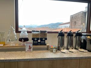 a kitchen counter with a bunch of appliances on it at Hotel San Pedro Plaza in Cusco