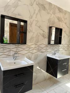 a bathroom with two sinks and a mirror at Mohammed Wadi Rum Camp in Wadi Rum