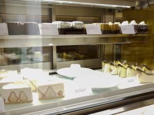 a display case in a bakery with different types of cakes at Eimiya Ryokan - Vacation STAY 36336v in Amakusa