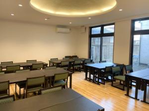 a dining room with tables and chairs and windows at Eimiya Ryokan - Vacation STAY 36320v in Amakusa