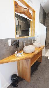 a bathroom counter with a mirror and a sink at Chambres d'Hôtes Doux Brazil in Lisle-sur-Tarn +38 photos
