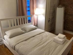 a bedroom with a white bed with two towels on it at Studio & Office -Walk anywhere Downtown + Hospital in Montréal +58 photos