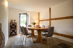 a dining room with a wooden table and chairs at Weingut Haus Steinbach in Radebeul