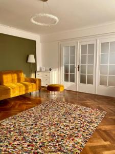 a living room with a couch and a rug at Cloos - Elegant Residence with Panoramic View in Braşov