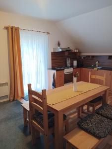 eine Küche mit einem Holztisch mit Stühlen und einem Esszimmer in der Unterkunft Ubytování Iris in Dolany