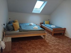 a room with two beds and a skylight at Ubytování Iris in Dolany