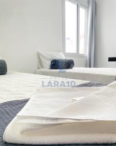 Postel nebo postele na pokoji v ubytování Hotel Lara 10 Curitiba