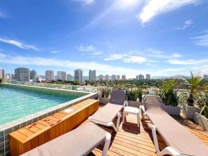 an outdoor deck with chairs and a swimming pool at View Luxury in Punta del Este