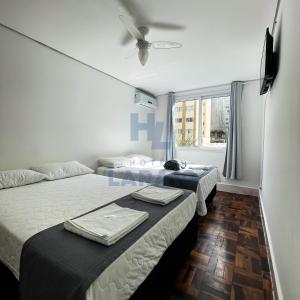 Postel nebo postele na pokoji v ubytování Hotel Lara 10 Curitiba