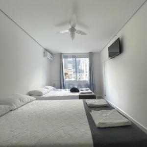 Postel nebo postele na pokoji v ubytování Hotel Lara 10 Curitiba