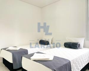Postel nebo postele na pokoji v ubytování Hotel Lara 10 Curitiba
