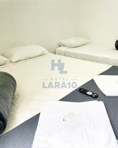 Postel nebo postele na pokoji v ubytování Hotel Lara 10 Curitiba