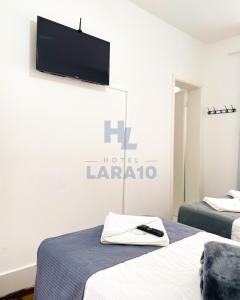 Postel nebo postele na pokoji v ubytování Hotel Lara 10 Curitiba