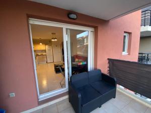 - un salon avec un canapé et une porte coulissante en verre dans l'établissement Nice Ouest St Isidore- 2P au calme, à Nice