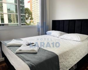Postel nebo postele na pokoji v ubytování Hotel Lara 10 Curitiba