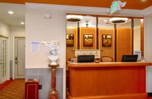 a lobby with a reception desk in a building at Brand Plaza Hotel in Glendale