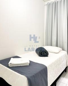 Postel nebo postele na pokoji v ubytování Hotel Lara 10 Curitiba
