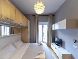 a bedroom with a large bed and a chandelier at Spanish Steps, Suite Dominic, Strollingrome in Rome