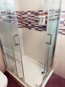 La salle de bains est pourvue d'une douche avec une porte en verre. dans l'établissement Casa Cobo Exclusivo Alojamiento en Madrid, à Madrid