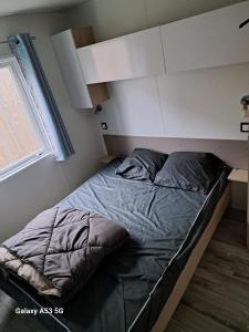a bed in a small room with at RIVA BELLA MH 171 in Ouistreham