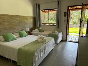 En eller flere senge i et værelse på Casa Passarinho