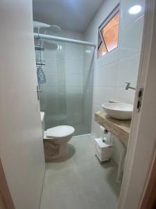 a bathroom with a toilet and a sink and a shower at Casinha da Nete (6 pessoas) in São Sebastião