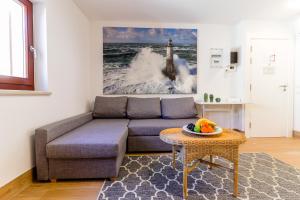 a living room with a couch and a table at Casanova Apartments - Viewpoint in Vrsar