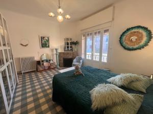 a bedroom with a bed with a teddy bear on it at VILLA MARYSE avec piscine privative in Saint-Laurent-de-la-Salanque