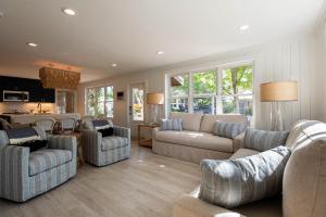 a large living room with couches and a kitchen at Artless Sprite in Santa Rosa Beach