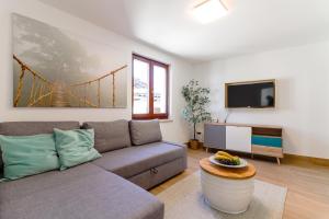 a living room with a couch and a tv at Casanova Apartments - Viewpoint in Vrsar