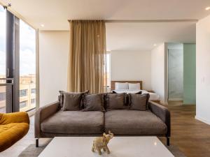 a living room with a couch and a bed at Kubik apartments in Exclusive Virrey in Bogotá