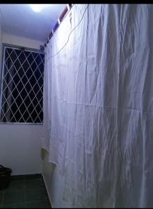 a shower curtain in a bathroom with a window at Chloe Isla 2 apartment Malindi in Malindi