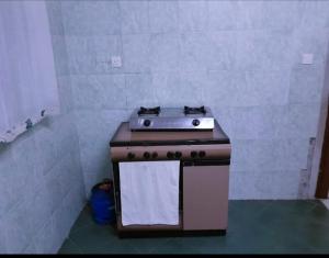 a kitchen with a stove with a towel on it at Chloe Isla 2 apartment Malindi in Malindi