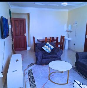 a living room with a couch and a table at Chloe Isla 2 apartment Malindi in Malindi