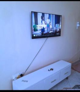 a flat screen tv hanging on a wall at Chloe Isla 2 apartment Malindi in Malindi