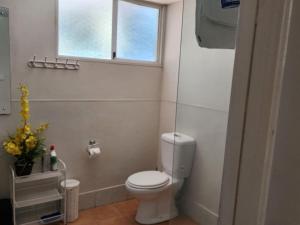 a bathroom with a white toilet and a window at Country Retreat The Blue Cottage in Gingin