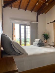 a bedroom with a large bed with pillows on it at Finca hotel la fortuna in San Pedro