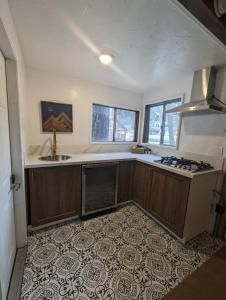 an empty kitchen with a sink and a stove at Three Pines Cabins in Big Bear Lake