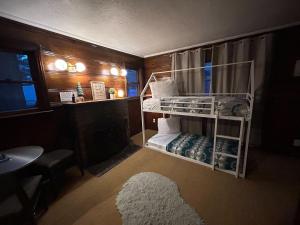 a small room with a bunk bed and a rug at Three Pines Cabins in Big Bear Lake