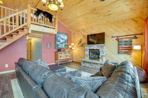 a living room with a leather couch and a fireplace at Spacious Gunnison Home Ski, Hike, Bike and Fish! in Gunnison