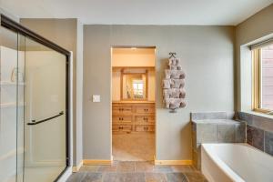 a bathroom with a tub and a shower and a sink at Spacious Gunnison Home Ski, Hike, Bike and Fish! in Gunnison +25 photos