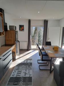 a kitchen with a table and a dining room at Ferienapartment "Zur Linde" in Breitenstein