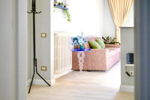 T&F HOUSE في سكانديتشي: غرفة معيشة مع أريكة وردية في غرفة