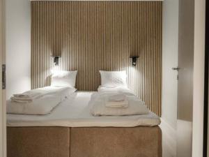 a bedroom with a bed with two pillows on it at Mountain Retreat for 4 in Are Ski-In Ski-Out Apt in Åre