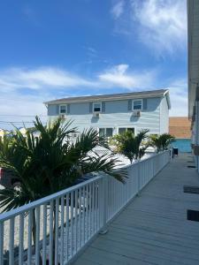 a house on a boardwalk next to the beach at Shipwreck Villa @ The Reef in Chincoteague